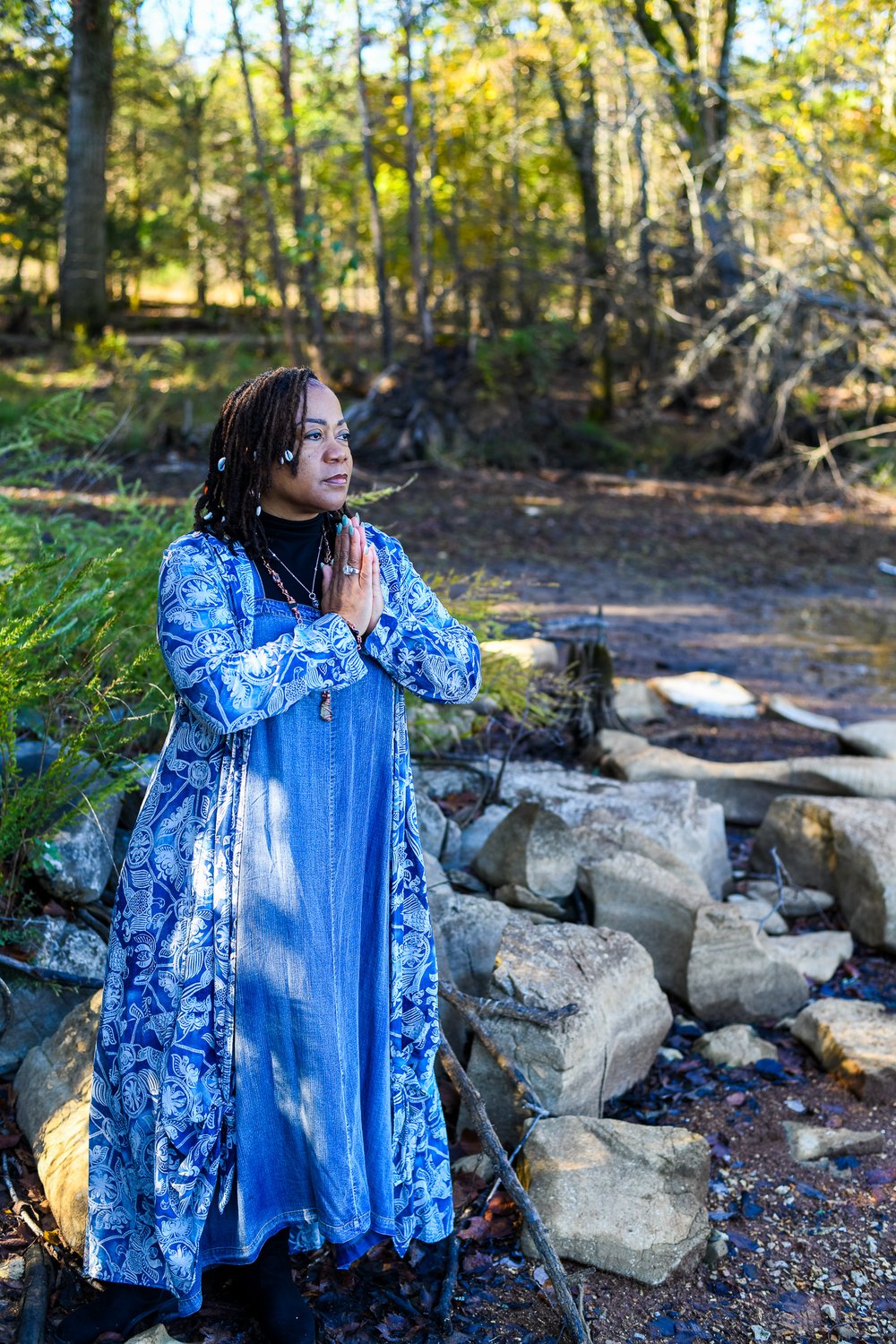 Rosilyn Hart in prayer at the lake, eyes closed